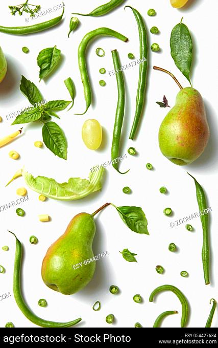 Green healthy drink. Vegetable juice, pears, leaves of basil and beans on the white background. Vegetarian food. Detox