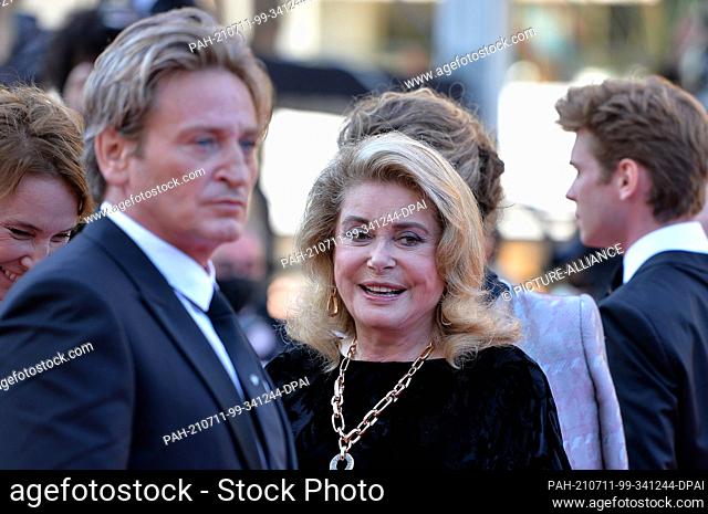 10 July 2021, France, Cannes: Benoit Magimel and Catherine Deneuve attend the screening of ""De Son Vivant"" (Peaceful) during the 74th Annual Cannes Film...