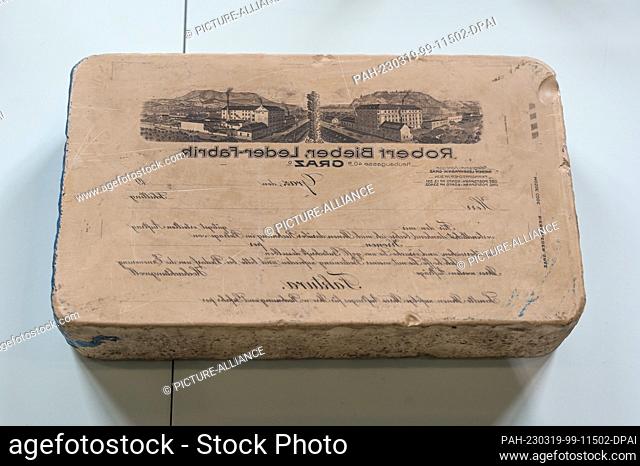19 March 2023, Saxony-Anhalt, Halle (Saale): A lithography stone (ca. 1875-1915) with the historical motif of the Robert Bieber leather factory is on display in...