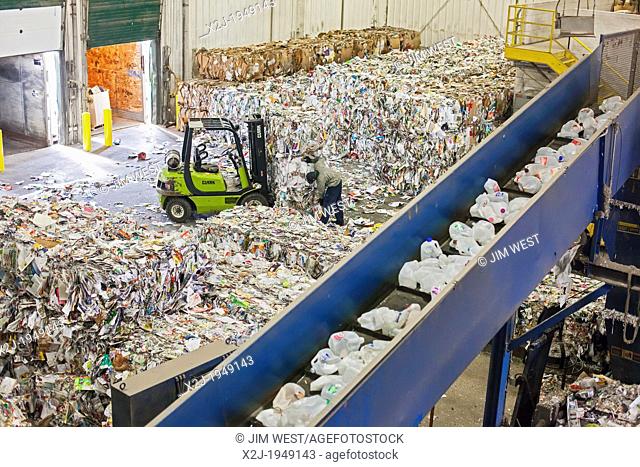Troy, Michigan - Low-wage workers sort paper, glass, plastic, and metals for recycling at the Southeastern Oakland County Resource Recovery Authority