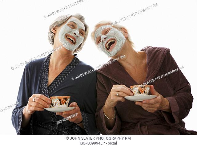 Senior women in beauty masks, laughing