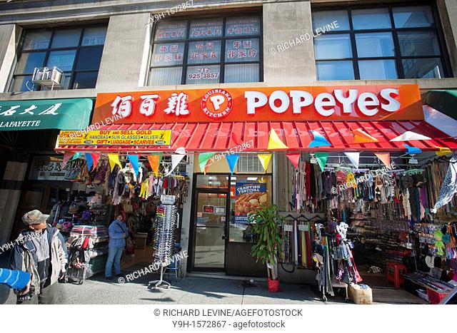 A Popeye's Louisiana Kitchen restaurant in Chinatown in New York with bilingual signage in Chinese and English