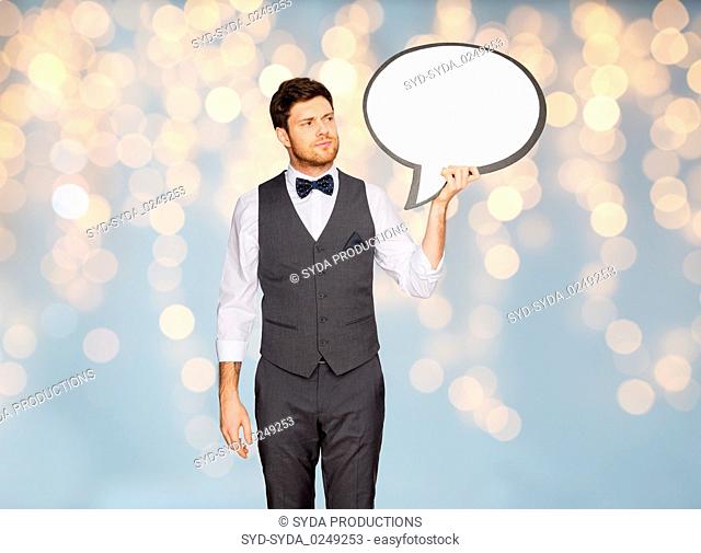 man in suit holding blank text bubble banner