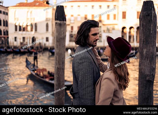 Affectionate young couple at the Canal Grande in Venice, Italy