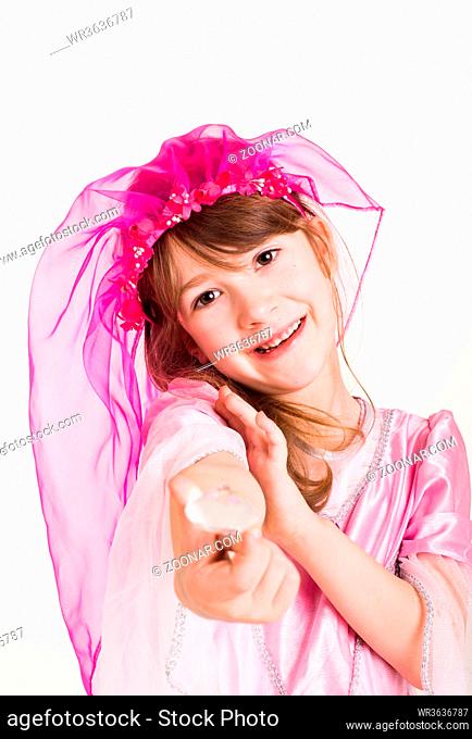little girl playing princess in a pink costume