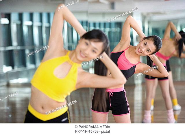 two women doing setting-up exercises