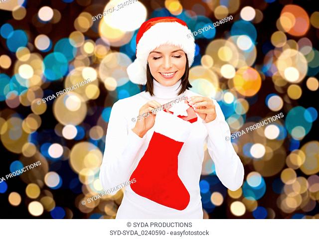 woman in santa hat with christmas gift and sock