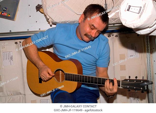 Cosmonaut Mikhail Tyurin, Expedition 14 flight engineer representing Russia's Federal Space Agency, plays a guitar in the Unity node of the International Space...