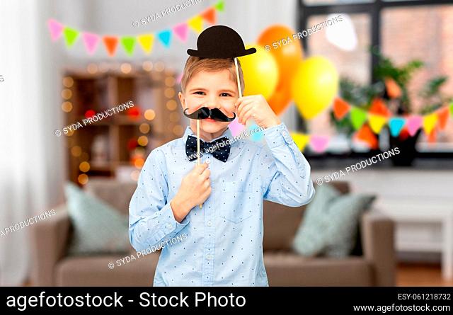 little boy with birthday party props and moustache