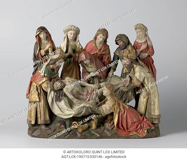 The Entombment, Nicodemus and Jozef van Arimathea stand opposite each other on a rocky, elongated plot, carrying the rigid body of Christ between them on a limp...