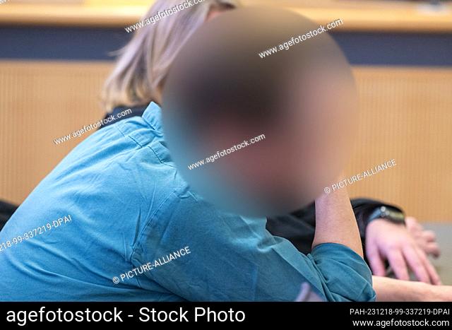 18 December 2023, Bavaria, Regensburg: The defendant sits in the courtroom of the district court. For 20 years, the man lived as a subtenant in a semi-detached...