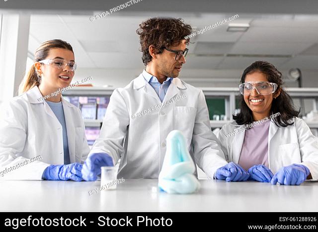 scientists with chemicals working in laboratory