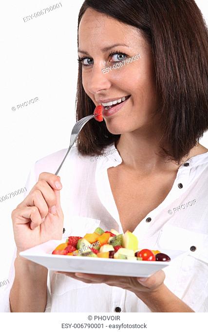 mid aged woman eating fruits salad