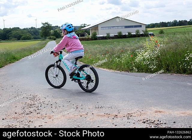 Bamberg, Germany May 26th, 2020: Symbolic images - 2020 child is riding a bicycle / child is wearing a helmet while cycling / child is riding a bicycle on the...