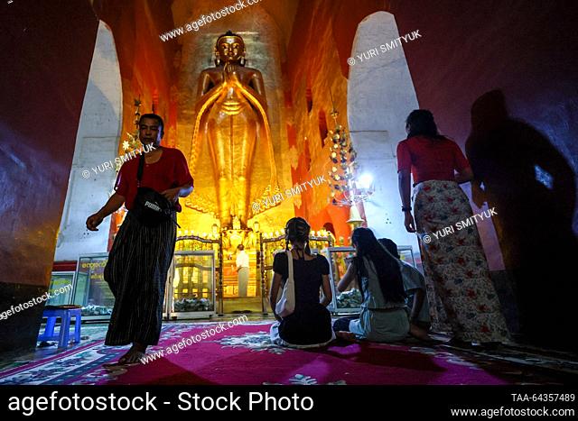 MYANMAR, BAGAN - OCTOBER 29, 2023: Locals pray in a Buddhist temple. Yuri Smityuk/TASS