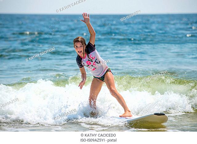 Young girl on surfboard in sea
