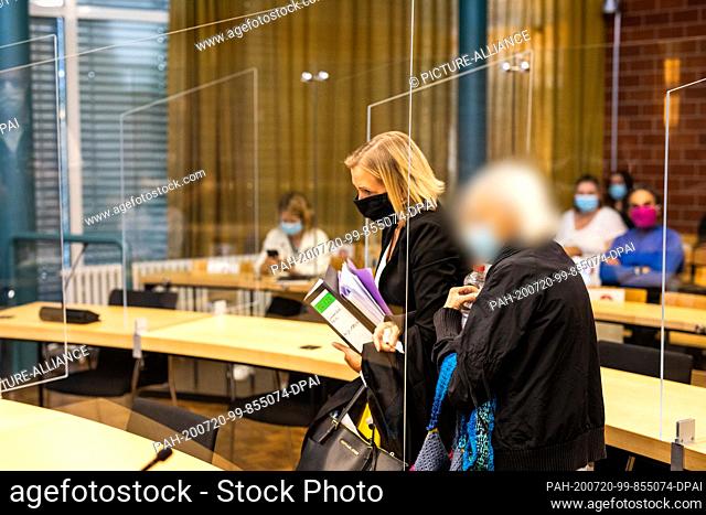 20 July 2020, Baden-Wuerttemberg, Konstanz: The accused 84-year-old woman (r) arrives at the courtroom of the Constance Regional Court