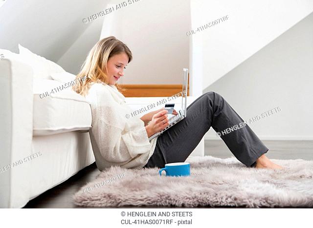 Woman shopping online in living room