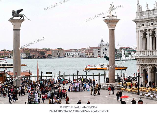 08 May 2019, Italy, Venedig: During the pre-opening period of the Venice 2019 Biennale, a boat can be seen on the water behind the St Mark and St Theodorus...