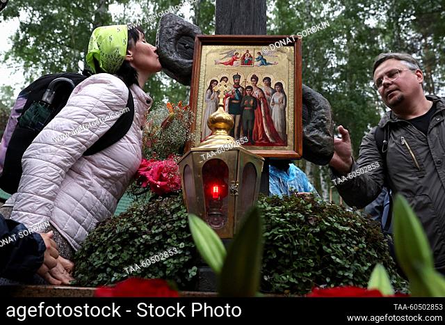 RUSSIA, SVERDLOVSK REGION - JULY 17, 2023: Believers are seen by a memorial cross at the Holy Royal Passion-Bearers Monastery at Ganina Yama after a religious...