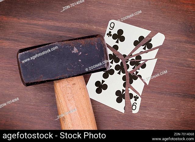 Hammer with a broken card, vintage look, nine of clubs
