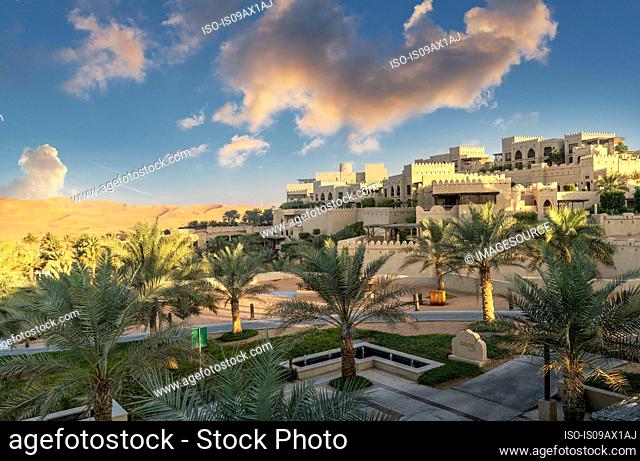 Palm trees in garden of Qsar Al Sarab desert resort, Empty Quarter Desert, Abu Dhabi, United Arab Emirate