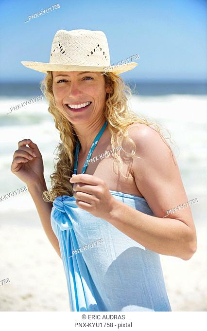 Portrait of a beautiful woman wearing sunhat and smiling