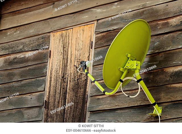 satellite dish at wooden house