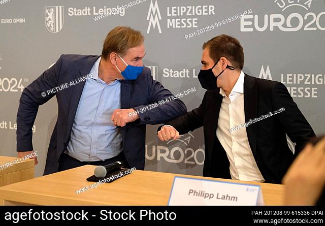 08 December 2020, Saxony, Leipzig: Leipzig's Lord Mayor Burkhard Jung (SPD/ l) welcomes Philipp Lahm, Managing Director of DFB EURO GmbH, with his elbow