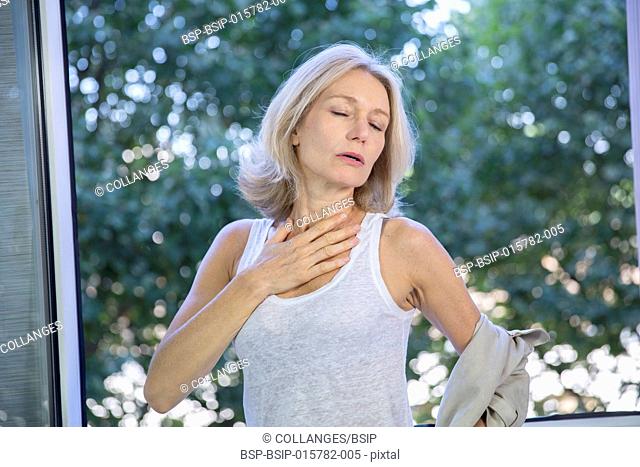A menopausal woman having a hot flush
