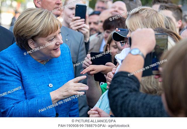 08 September 2019, Saxony-Anhalt, Dessau-Roßlau: Federal Chancellor Angela Merkel (CDU) welcomes the population before the opening ceremony of the Bauhaus...