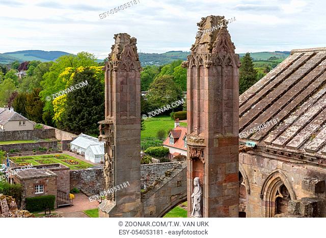 Aerial view from ruins of Melrose abbey to courtyard with garden in Scottish highlands