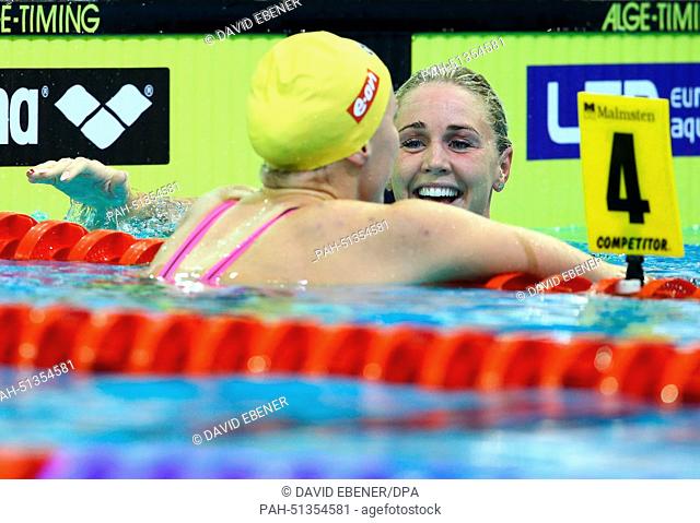 Winner Jeanette Ottesen of Denmark (R) and second placed Sarah Sjoestroem of Sweden react after the women's 100m Butterfly at the 32nd LEN European Swimming...