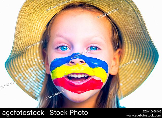 Laughing little girl in straw hat with painted face having fun. Isolated on white