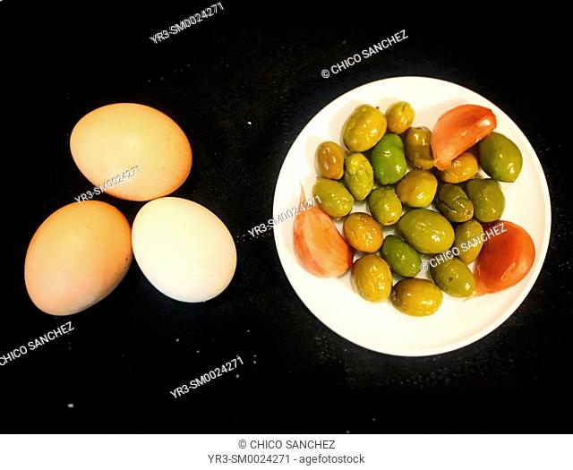 Free range eggs and olives with garlic in Prado del Rey, Sierra de Cadiz, Andalusia, Spain