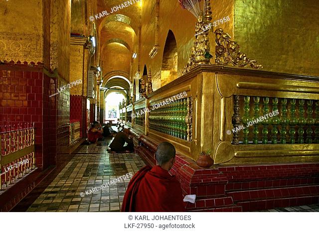 Buddhist monk praying in Mahamuni Pagoda, Mandalay, Burma, Myanmar