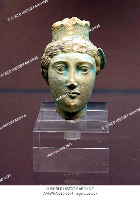 Spout of a faience vessel in the form of an early Ptolemaic queen. Egypt. Dated 3rd Century BC