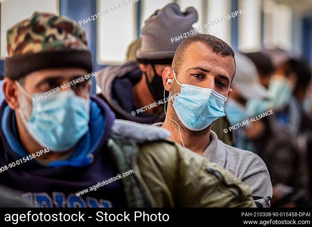 08 March 2021, Israel, Meitar: Palestinian cross-border workers wait for their turn to receives their COVID-19 vaccine jabs at a vaccination centre opened at...