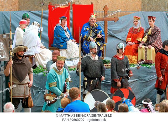 Actors dressed as Emperor Otto I (BACK 3-R) and Adelheid (BACK 4-R) participate in a pageant show in Quedlinburg, Germany, 19 May 2013