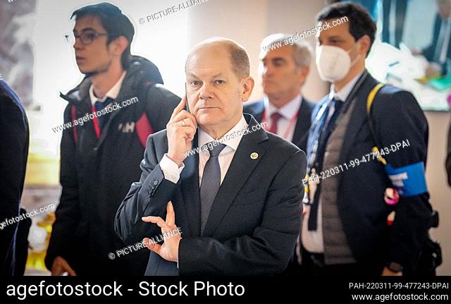 11 March 2022, France, Versailles: German Chancellor Olaf Scholz (SPD) speaks on the phone on the sidelines of the meeting of European Union EU heads of state...