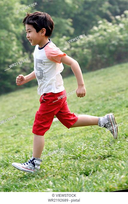 Boy playing football in field