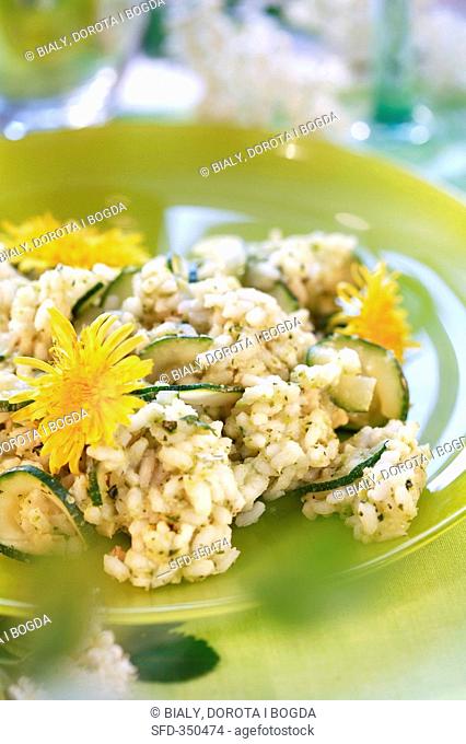 Courgette risotto garnished with edible dandelion flowers