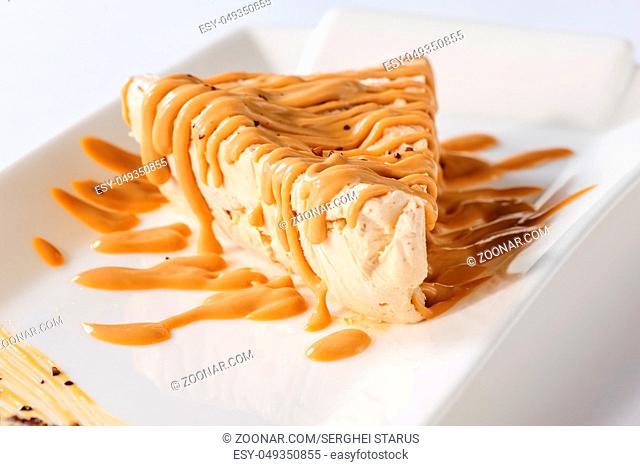 Delicious frozen cheesecake with caramel and sweet condensed milk topping