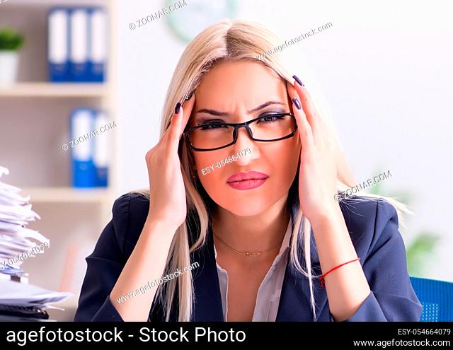 The busy businesswoman working in office at desk