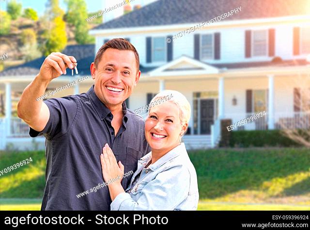 Happy Couple With New House Keys In Front Beautiful House