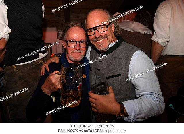 28 September 2019, Bavaria, Munich: John Helliwell (l), musician of the rock band Supertramp, celebrates with media consultant Peter Olsson in the Käfer tent on...