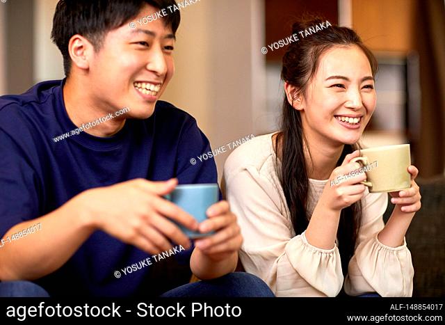 Young Japanese couple at home