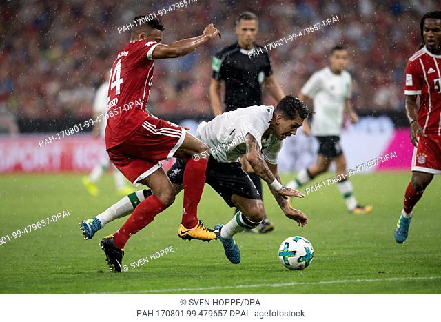 Bayern Munich's Corentin Tolisso (L) and Liverpool's Roberto Firmino vie for the ball during the Audi Cup semi-final pitting FC Bayern Munich vs FC Liverpool at...