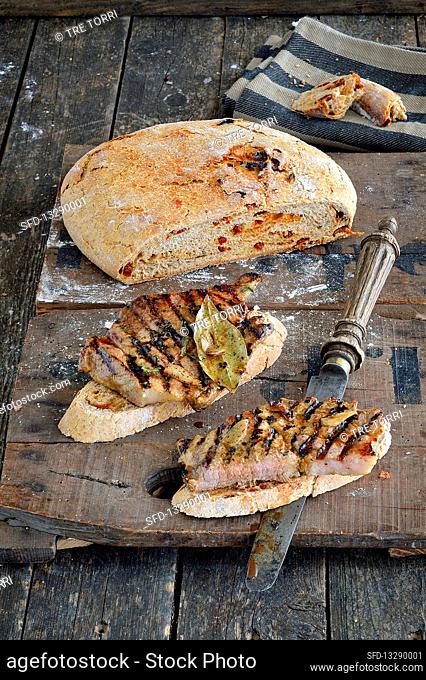 Grilled pork neck steaks with homemade bread