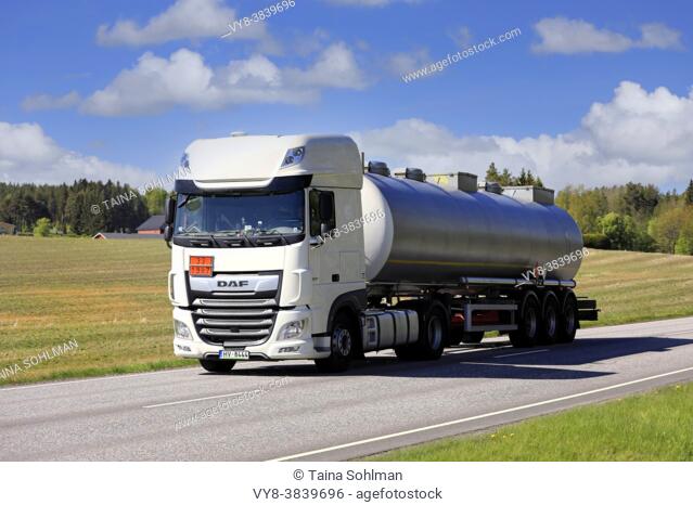 White DAF XF semi tanker truck hauls ADR 33-1987 Alcohols N. O. S. dangerous goods along highway in the spring. Salo, Finland. May 17, 2019